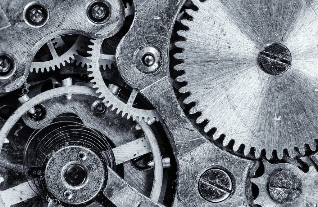 Close-up view of interlocking metal gears and cogs in a mechanical system, representing the complexity and precision of locking mechanisms.